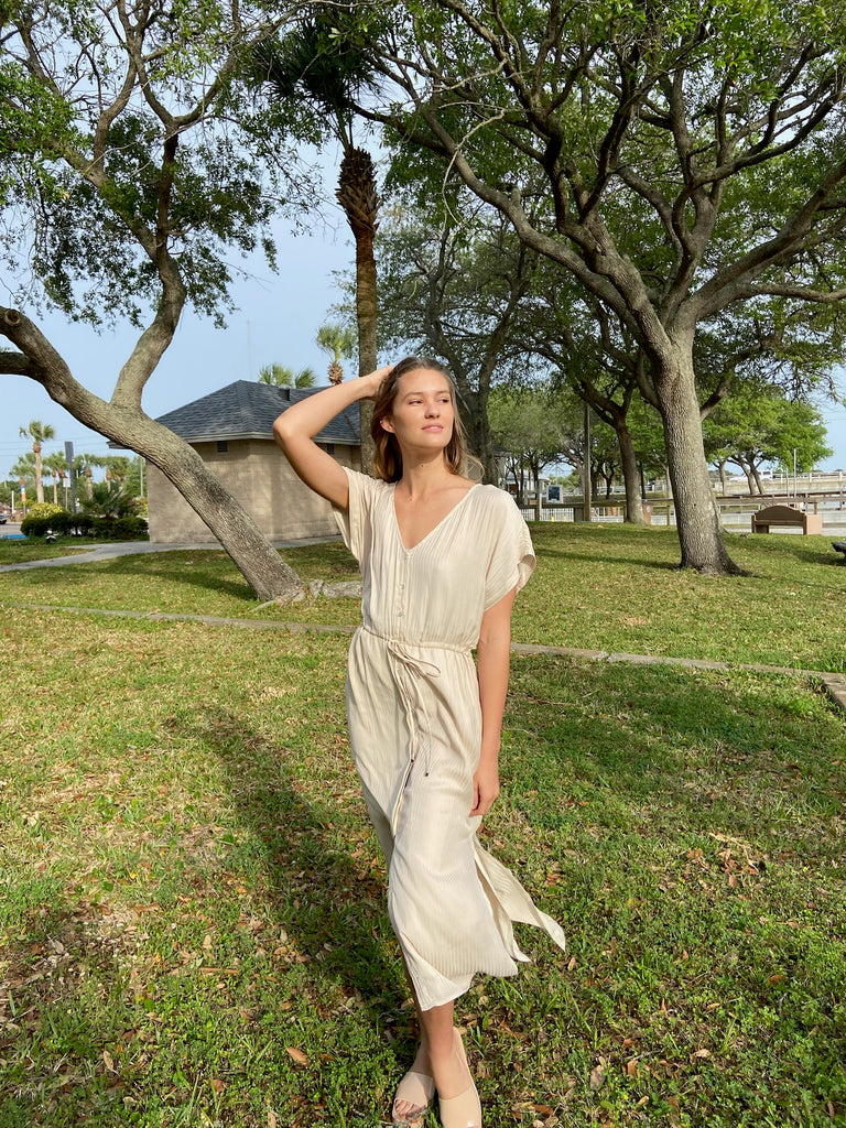 Model in Park Wearing a Beige Dress